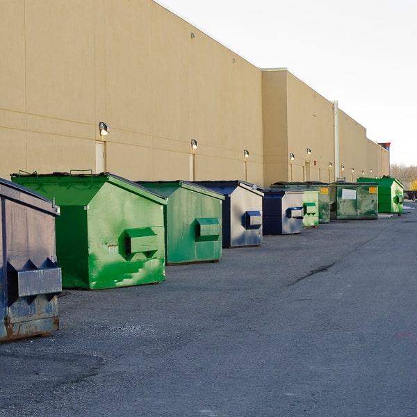 large commercial dumpster placed in a parking lot